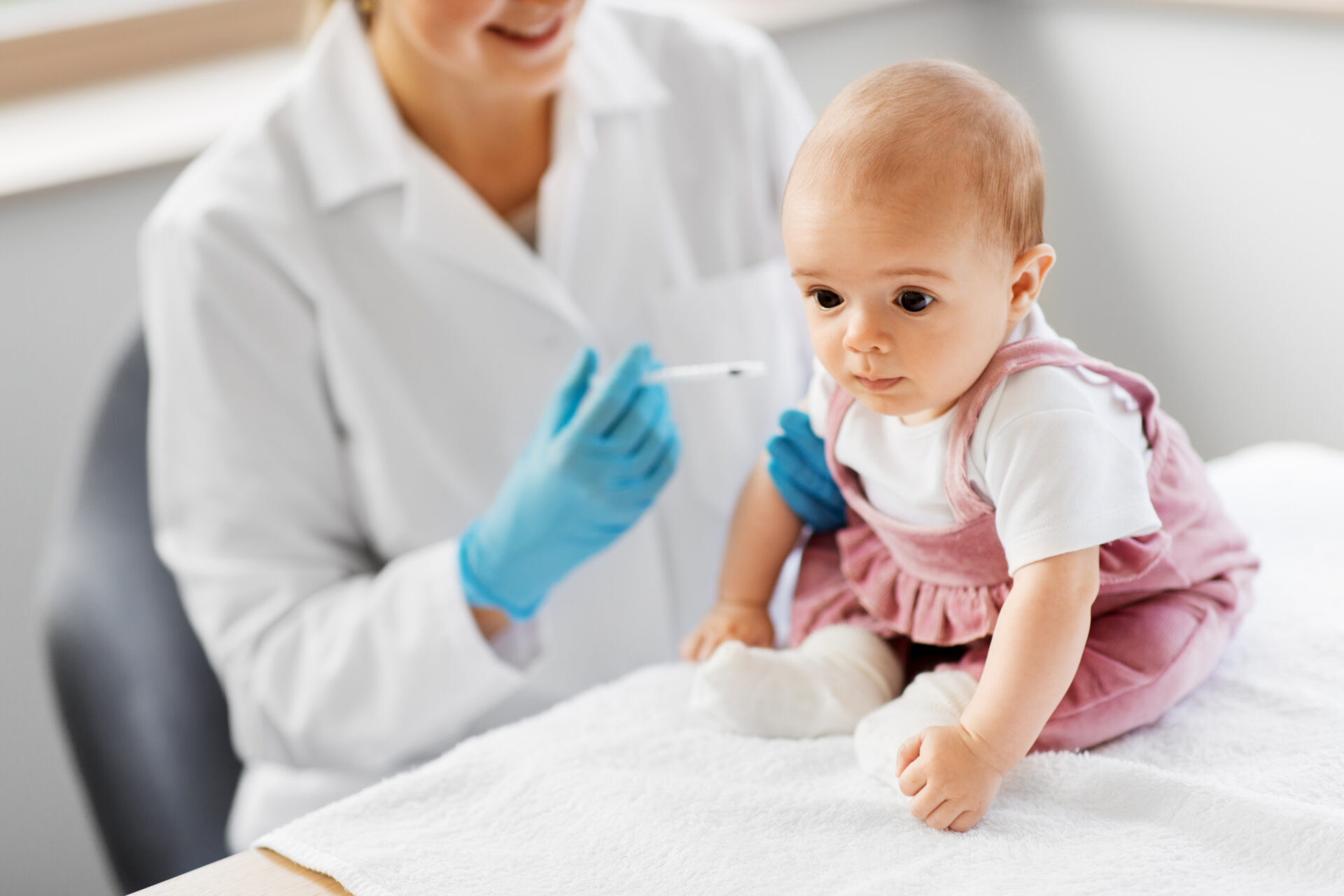 baby girl getting a vaccine from a healthcare professional